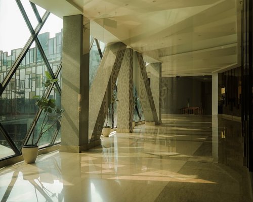 A modern office lobby interior in Jakarta with warm lighting and plants